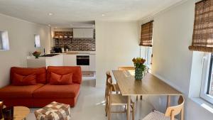 a living room with a couch and a table at Tidal Nest - North Sea Stays in Wenduine