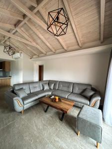 a living room with a couch and a table at Golden View Berat, 3BR Apartment with Castle View & Parking in Berat