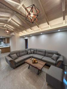 a living room with a couch and a table at Golden View Berat, 3BR Apartment with Castle View & Parking in Berat