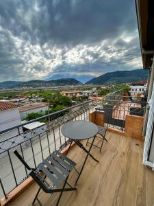 a table and chairs on a balcony with a view at Golden View Berat, 3BR Apartment with Castle View & Parking in Berat +38 photos
