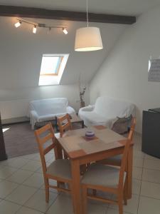 a living room with a table and chairs and a couch at Ubytování Hana Foltýn in Pavlov
