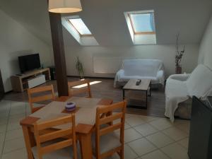 a living room with a table and a couch at Ubytování Hana Foltýn in Pavlov