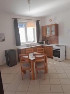 a kitchen with a table and chairs and a kitchen with a stove at Ubytování Hana Foltýn in Pavlov +7 photos