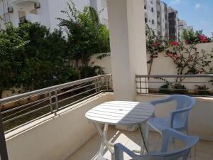 a table and two chairs sitting on a balcony at Confort house in Nabeul