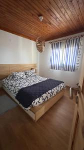 a bedroom with a bed and a large window at Longitude 31 House in Faja Grande