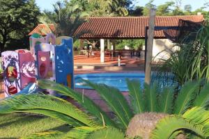 a resort with a swimming pool and a pavilion at Amanecer del Monday in Puerto Presidente Franco