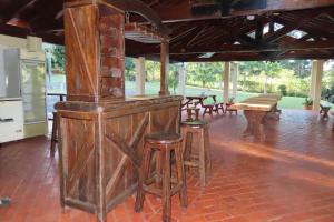 a bar with stools and a table in a room at Amanecer del Monday in Puerto Presidente Franco
