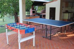 a ping pong table sitting on a brick patio at Amanecer del Monday in Puerto Presidente Franco