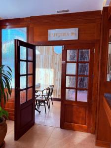 an open door to a restaurant with a table at Hotel Vadorrey in Roa
