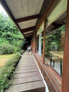 a wooden walkway on the side of a house at Casa Amparo in Frutillar +3 photos