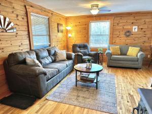 a living room with a couch and a table at Connie's Little House in Elmira +27 photos