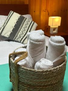 a basket filled with towels on a bed at Casa Amparo in Frutillar