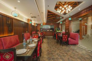 a dining room with tables and chairs and a restaurant at Hotel Heritage Street ! 100m from Golden Temple ! Parking & Restaurant in Amritsar