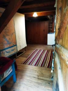 an attic room with a rug on the floor at Hostal Nunatak in La Porteña