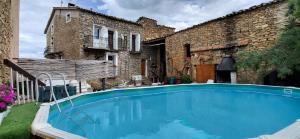 an outdoor swimming pool in front of a building at Can Manuel in Gabet