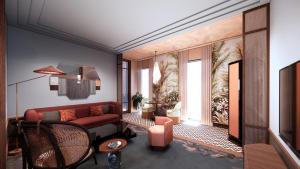 a living room with a red couch and a window at FAIRMONT NEW ORLEANS in New Orleans