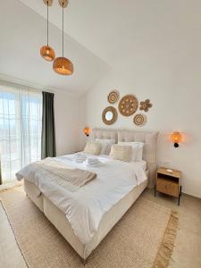 a bedroom with a large bed with white sheets at Casa Katarina in Novalja +43 photos