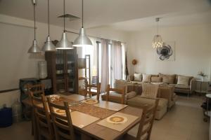 a living room with a table and a couch at Samarah Resort Apartment D32 at DeadSea, Sea & Pool view- Families & couples only in Sowayma