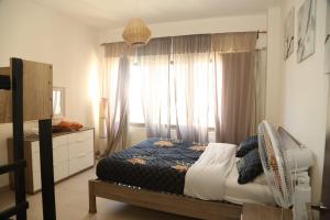 a bedroom with a bed in front of a window at Samarah Resort Apartment D32 at DeadSea, Sea & Pool view- Families & couples only in Sowayma +62 photos