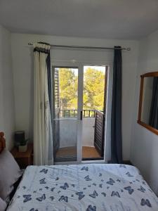 a bedroom with a bed and a large window at casa Caithlyn in Peniscola +9 photos
