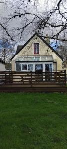 a wooden bench in front of a house at Clifden Glen House in Clifden