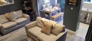 a living room with two couches and a table at Clifden Glen House in Clifden