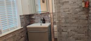 a bathroom with a sink and a shower at Clifden Glen House in Clifden +34 photos