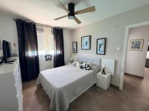 a bedroom with a bed and a ceiling fan at Faro de Cullera I in Faro de Cullera