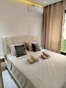 a bedroom with a bed with two slippers on it at Riad Andalous in Ariana