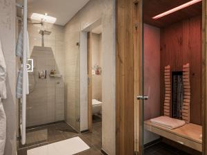 a bathroom with a shower and a toilet and a sink at Landhaus Mader Hintertux in Tux +19 photos