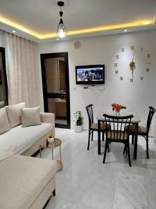 a living room with a couch and a table at Riad Andalous in Ariana
