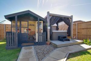 a small shed with a grill in a yard at 2 Bed in Walcott oc-2301 in Walcott +7 photos