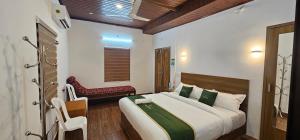 a bedroom with a large bed and a red bench at Johny's Villa, Homestay, Wayanad in Pulpally +37 photos