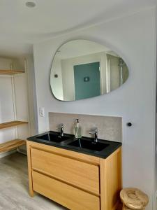 a bathroom with a sink and a mirror at Etoile du Kap in Barneville-Carteret +30 photos