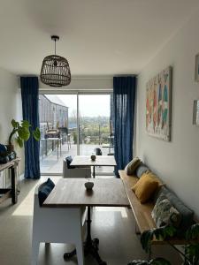 a living room with a couch and a table at Etoile du Kap in Barneville-Carteret