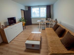 a living room with a couch and a table at Apartmán Gerlach in Vyšné Hágy