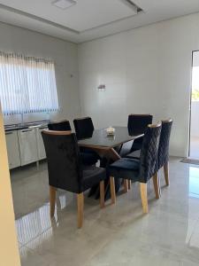 a dining room with a table and chairs at WS Hotel in Campo Alegre