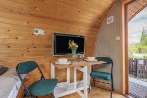 a room with a table and two chairs and a tv at 1 Bed in Barnacre oc-b34348 in Catterall