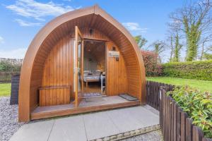 a wooden gazebo in a garden with a fence at 1 Bed in Barnacre oc-b34348 in Catterall