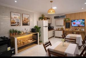 a kitchen with a counter with food in it at Pousada Meu Aconchego in Fortaleza