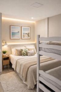 a bedroom with two beds and a bunk bed at Pousada Meu Aconchego in Fortaleza
