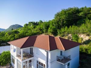 a white house with a brown roof at Apartman VITINA in Ljubuški