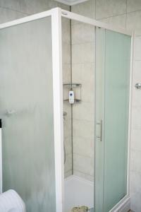 a shower with a glass door in a bathroom at Apartman VITINA in Ljubuški +17 photos