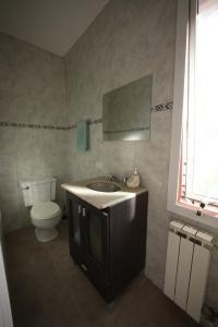 a bathroom with a sink and a toilet at Casa Juanca in Comodoro Rivadavia