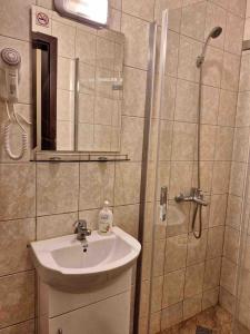 a bathroom with a sink and a shower at KiShouse in Burgas