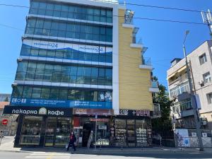 a building on a city street with people walking in front at KiShouse in Burgas