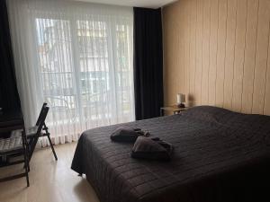 a bedroom with a bed and a large window at KiShouse in Burgas