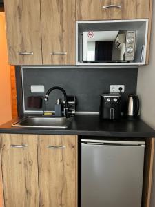 a kitchen with a sink and a microwave at KiShouse in Burgas