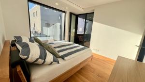 a bed in a room with a large window at Alte Weberei in Marktredwitz