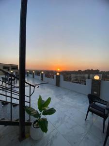 a view of the sunset from the roof of a building at Families Pyramids view - Rooftop in Cairo